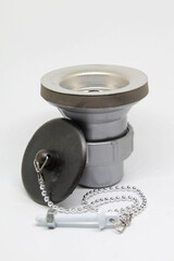 Bath sink plughole set and rubber plug with chain on white background.
