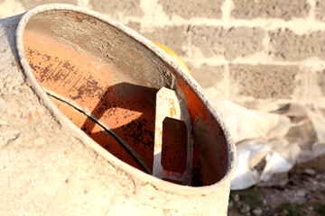 concrete mixer against a gray wall