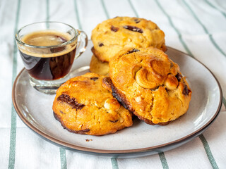 Chewy chocolate chip soft cookies with cup of hot black coffee, selective focus on cookies