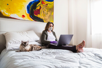 young woman with laptop. Coronavirus season covid19. . accompanied by a cat. Concept of staying at...