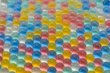 Many colourful gel balls. Hydrogel beads for background.