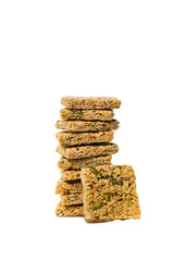 Multigrain Cereal Crunchy Squares Bars with Pumpkin Seeds Background. Healthy Bar Snack on White Background. Selective focus.