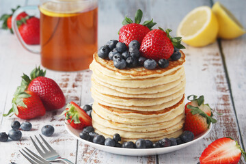 A stack if home-made pancakes with berry