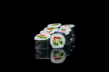 Sushi Roll On A Black Background reflection . Japanese food. Close Up.