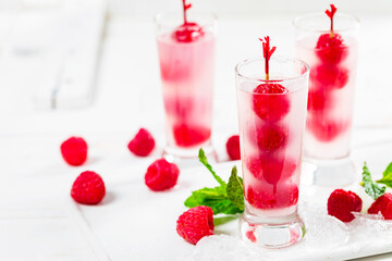 Raspberry Tequila Shots Lemonade Cocktail with Fresh Raspberry on White Background. Selective focus.