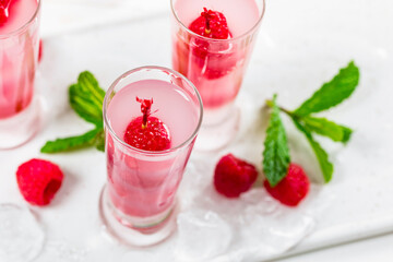 Raspberry Tequila Shots Lemonade Cocktail with Fresh Raspberry on White Background. Selective focus.