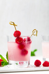Raspberry Vodka Pink Lemonade Cocktail with Fresh Raspberry Background. Selective focus.