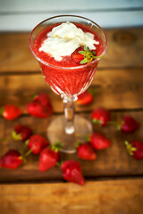 cocktail with fresh strawberries on an old rustic table