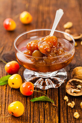 Cherry Jam with Nuts. Azerbaijani Cuisine White Cherry Preserves on Wooden Background. Selective focus.