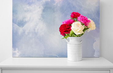 Vase with beautiful peony flowers on table