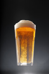 Glass of beer on black background, copy space