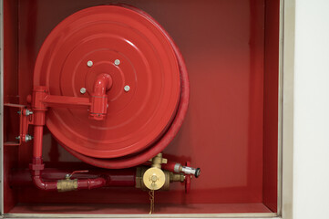 Rescue firefighter equipment, fire line in red box.Fire hose reel in the public building area.Fire...