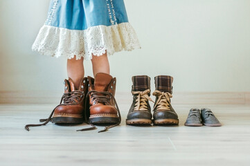 Wooden toys, clothes and shoes on green background