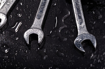 Close up Three wrench with spray on black background.