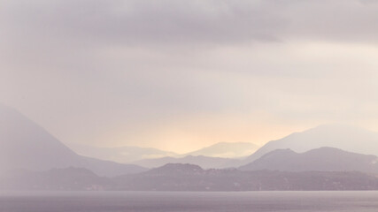sunset over a lake with rain