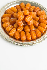 Traditional Turkish Crispy Pastry Dessert,Tulumba in the vintage metal tray on white with copy space.Vertical image