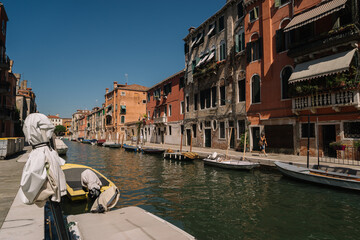 Only one woman is walking along the Cannaregio canal in Venice, Italy.