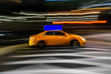 Fototapeta na wymiar New York City yellow taxi cab in motion across broadway in Manhattan