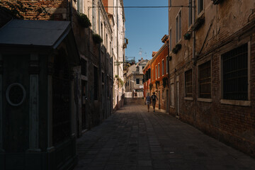 People are walking on the street of Cannaregio district in Venice, Italy.