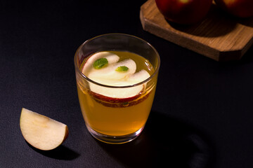 Summer apple drink, refreshing fermented on a black background. Copy space