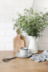 Rustic kitchen interior. Still life composition with cup of coffee, wooden chopping boards and cow...