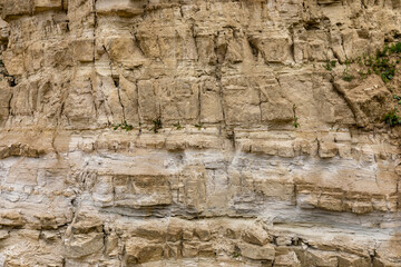 Limestone rock slope wall texture background in natural landscape, former open-pit stone quarry. Landscape changed by human impact. Nowiny quarry near Jozefow, Poland, Europe.