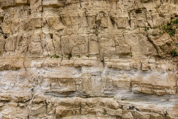 Limestone rock slope wall texture background in natural landscape, former open-pit stone quarry....