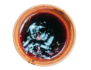 A red wine is dripping in the traditional Georgian clay cup