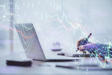 Multi exposure of forex chart with man working on computer on background. Concept of market analysis.