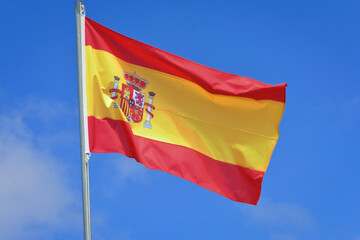 Spain flag in the wind on the top of the mast