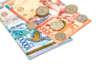 Closeup of a collection of Kazakhstani tenge banknotes on white background