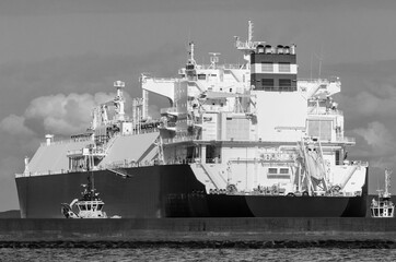MARITIME TRANSPORT - The LNG tanker maneuvers for mooring at gas port terminal

