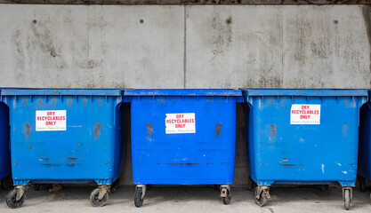 Big blue recycling containers for recycling plastics, paper and cans