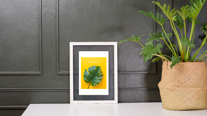 Interior wall Picture frame mockup with a leaf