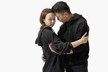 Support. Trendy fashionable couple isolated on white studio background. Stylish woman and man posing in basic minimal stylish clothes equally suitable for both. Concept of equality, inclusive.