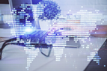 Double exposure of businessman working on laptop on background. International business hologram in front. Concept of success.