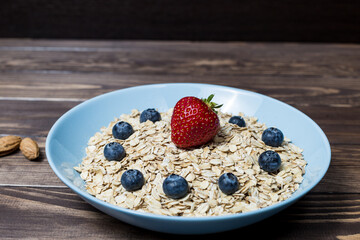 healthy breakfast. oatmeal with blueberries and strawberries.
