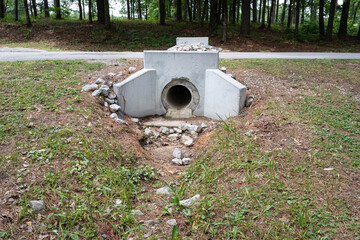 New cast concrete headwall to provide rainwater runoff path under a street, environmental issues,...