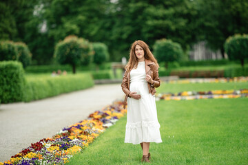 pregnant brunette woman at an old building gazebo.