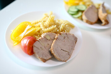 on table are plates food, meat and side dish