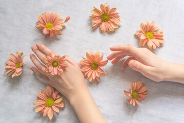 Hands of a beautiful woman on a white background. Delicate palm with natural manicure, clean skin. Light white nails. Hand Care.