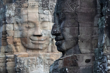 Fototapeta na wymiar Giant smiling stone faces adorn Bayon Temple in Cambodia