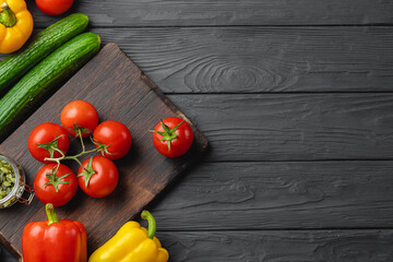 Top view of ripe vegetables on black wooden board