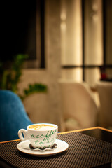 Cup of coffie in japoneese-style caffe in warm lighted evening 