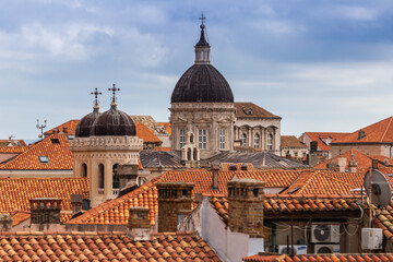 Fototapeta na wymiar The domed rooftops of Old Town, Dubrovnik Croatia rise above the terra cotta roof lines
