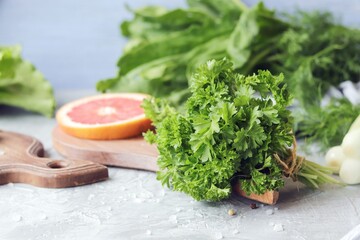 
Fresh herbs, citruses, spices on a gray grunge surface on a window background, organic products, healthy food, seasonal home cooking