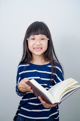 Portrait of young Asian girl kid on white background thinking of new ideas, day dreaming, acting like a smart genius.