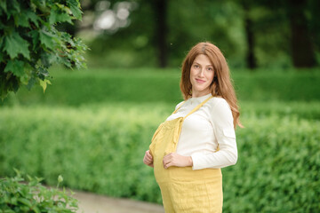 pregnant brunette woman at an old building gazebo.