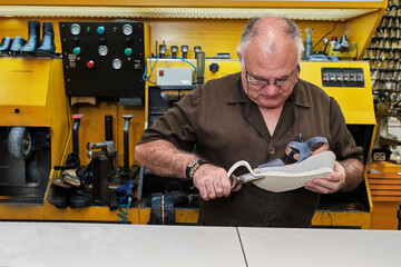 shoemaker man working in his shoe shop