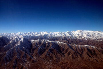 Aerial photograph taken of the Hindu Kush mountain in winter with snow covering the peaks